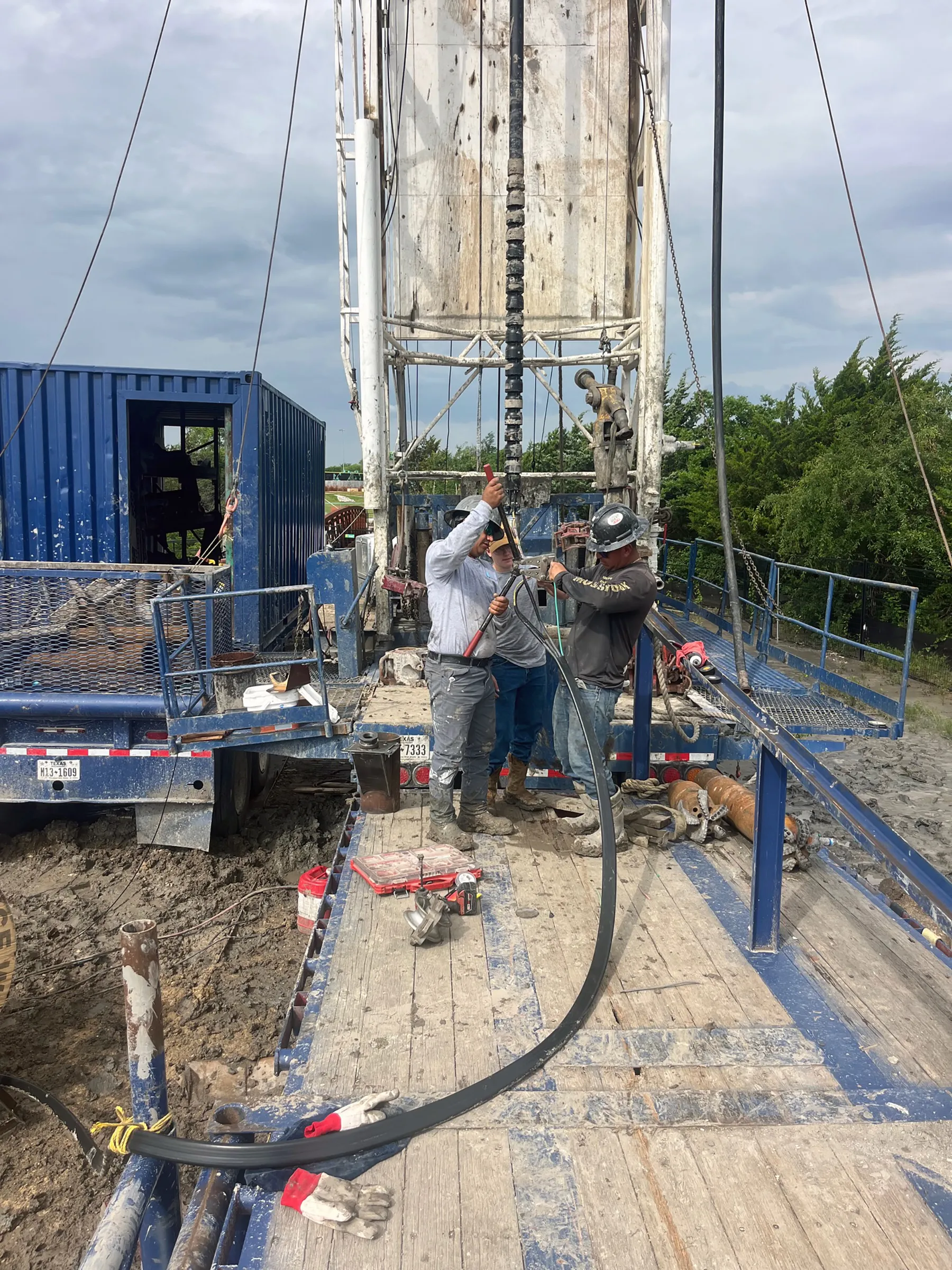 DFW Well Service crew running steel casing on a North Texas water well
