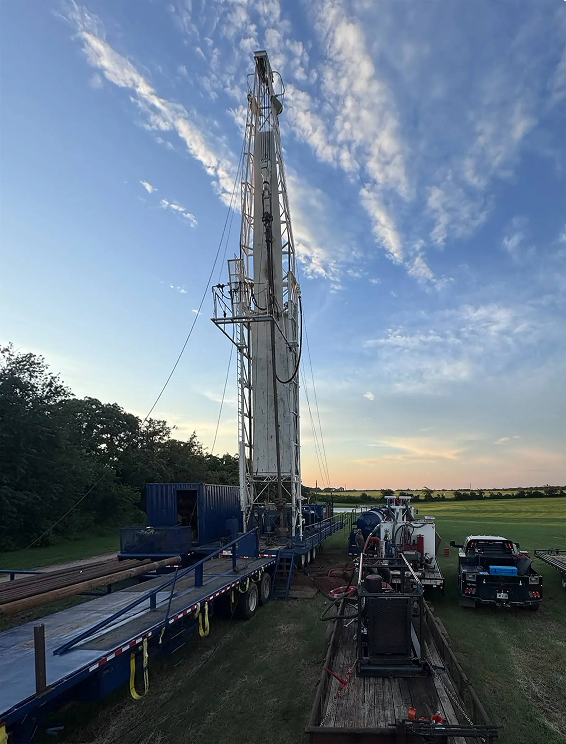 Water well drilling rig at sunset on a North Texas job site